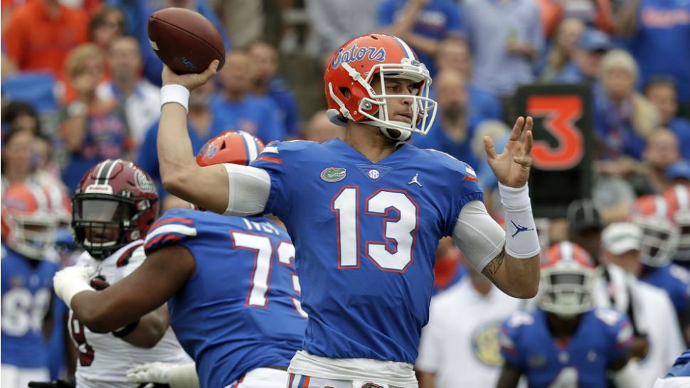 Florida quarterback Feleipe Franks (13) throws a pass as he is pressured by the South Carolina defense during the first half of an NCAA college football game, Saturday, Nov. 10, 2018, in Gainesville, Fla. (AP Photo/John Raoux)
