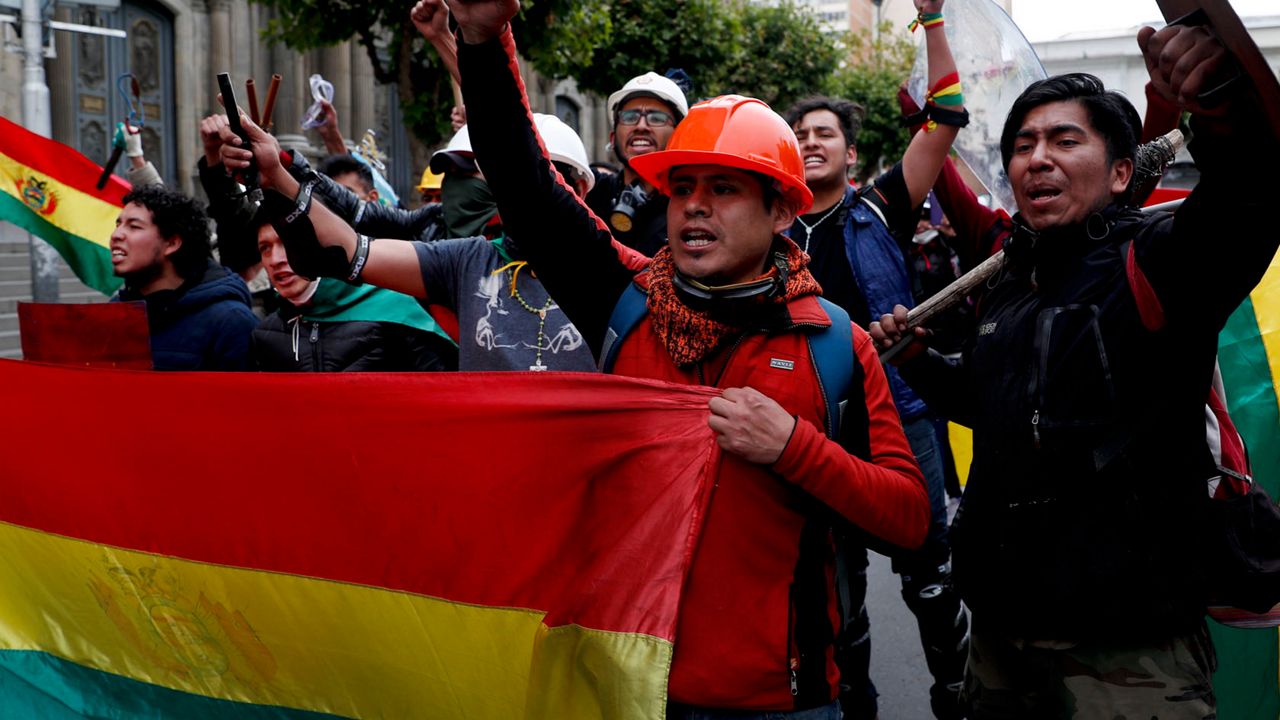 Opponents of Bolivia's President Evo Morales celebrate after he announced his resignation to the presidency, in La Paz, Bolivia, Sunday, Nov. 10, 2019. (AP Photo/Juan Karita)