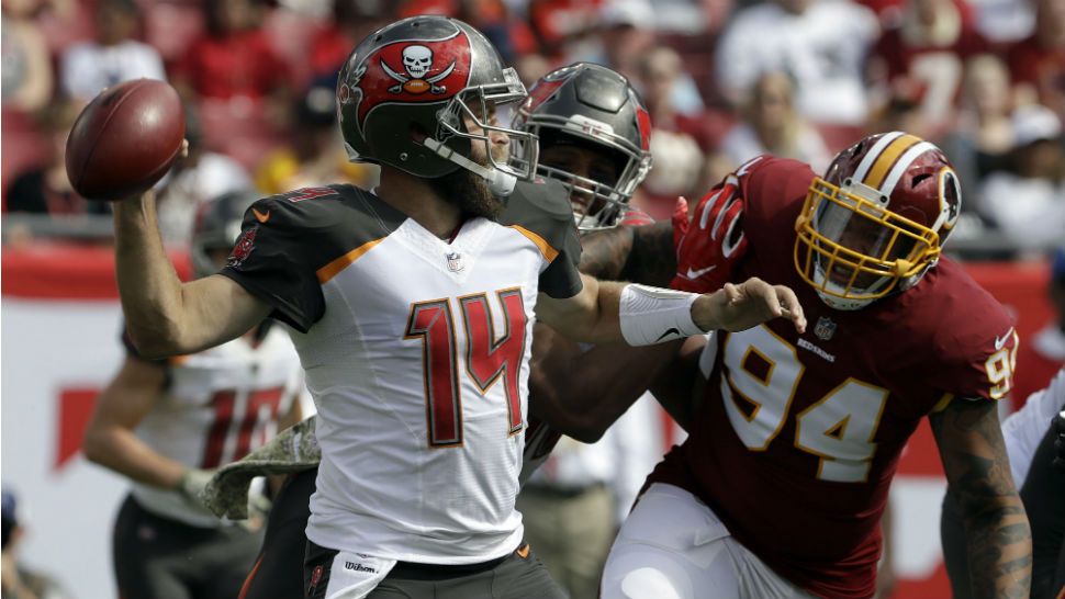 Tampa Bay Buccaneers quarterback Ryan Fitzpatrick (14) throws a pass as he is pressured by Washington Redskins outside linebacker Preston Smith (94) during the first half of an NFL football game Sunday, Nov. 11, 2018, in Tampa, Fla. (AP Photo/Chris O'Meara)