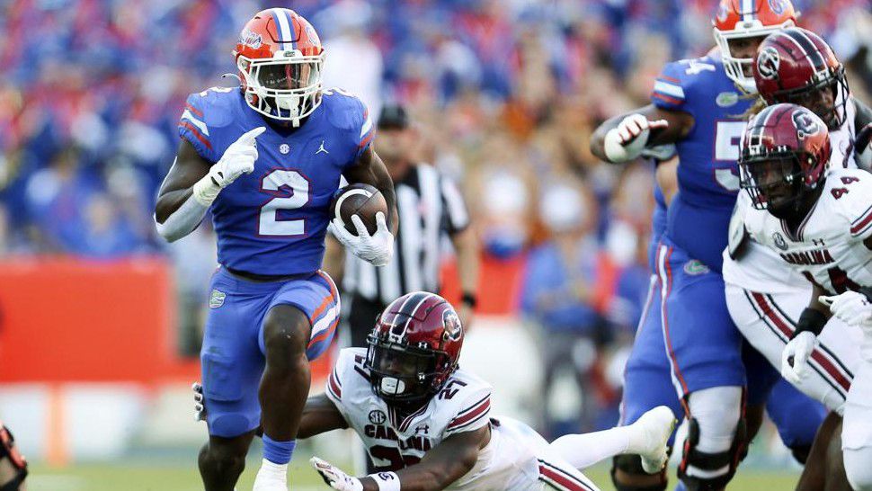 Florida running back Montrell Johnson Jr. (2) runs up the field past South Carolina defensive back Nick Emmanwori (21) during the first half of an NCAA college football game, Saturday, Nov. 12, 2022, in Gainesville, Fla. (AP Photo/Matt Stamey)