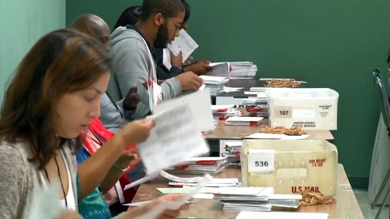 Volunteers recounting votes in Florida. (Spectrum News image)