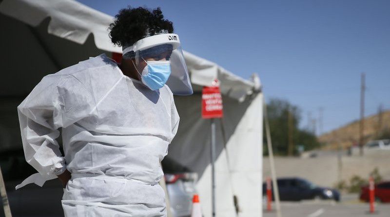 In this Oct. 26,2020, file photo, a medical worker stands at a COVID-19 state drive-thru testing site at UTEP, in El Paso, Texas. (Briana Sanchez/The El Paso Times via AP, File)