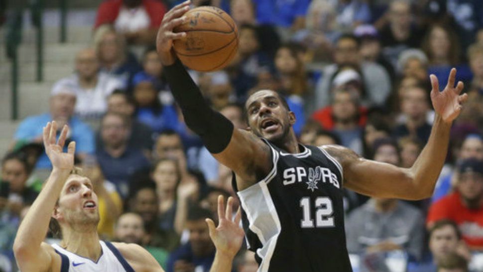San Antonio Spurs forward LaMarcus Aldridge (12) grabs the ball in front of Dallas Mavericks forward Dirk Nowitzki (41), of Germany, during the first half of an NBA basketball game in Dallas, Tuesday, Nov. 14, 2017. (AP Photo/LM Otero)
