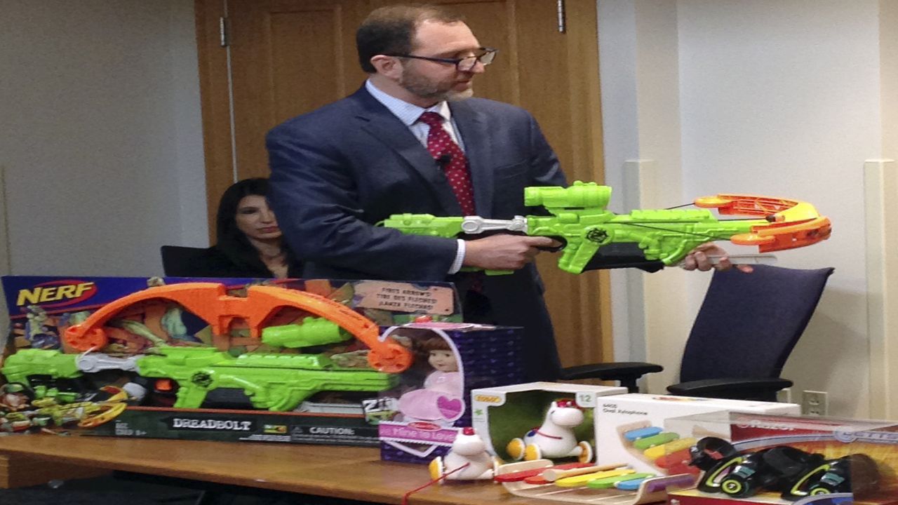 James Swartz, director of World Against Toys Causing Harm, or W.A.T.C.H., displays Nerf's "Zombie Strike" crossbow during a news conference Tuesday, Nov. 14, 2017, in Boston, where the child safety group released its annual holiday list of the 10 most hazardous toys. (AP Photo/Philip Marcelo)