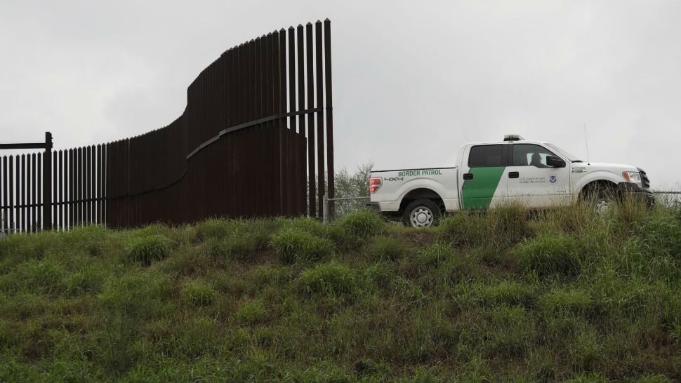 FILE - This Nov. 13, 2016, file photo shows a U.S. Customs and Border Patrol agent passes along a section of border wall in Hidalgo, Texas. The U.S. government has awarded a $167 million contract to build 8 miles of border wall in south Texas. U.S. Customs and Border Protection announced the contract Wednesday, Nov. 14, 2018. Construction will begin in February. (AP Photo/Eric Gay, File)