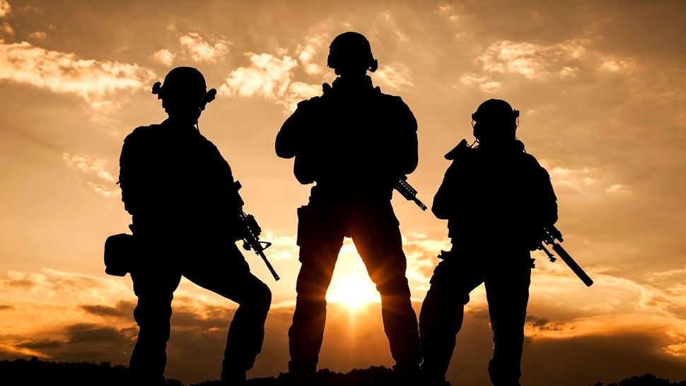 Generic photograph of servicemen standing in front of a sunset (Spectrum News file photograph)