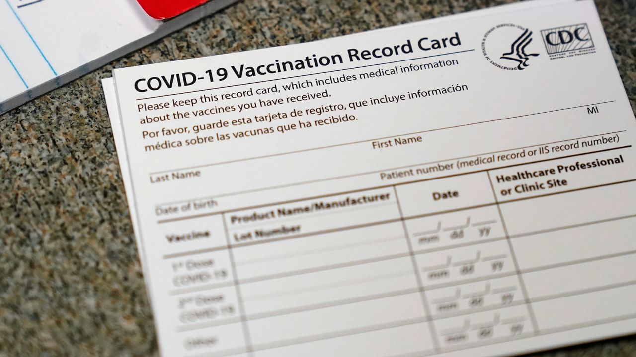 In this Dec. 24, 2020, file photo, a COVID-19 vaccination record card is shown at Seton Medical Center in Daly City, Calif. (AP Photo/Jeff Chiu, File)