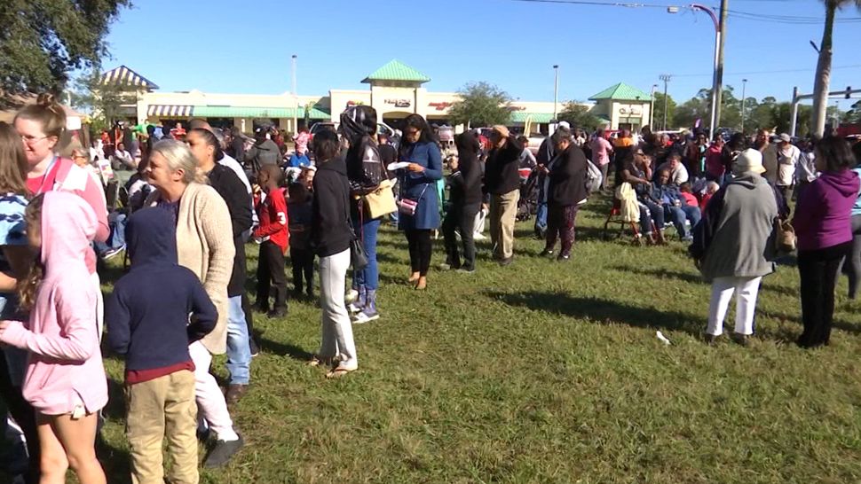 Hundreds of residents came out Saturday to get the main dish of their Thanksgiving meal at the Turkey giveaway at the Alpizar Law Firm in Palm Bay. (Krystel Knowles/Spectrum News 13)