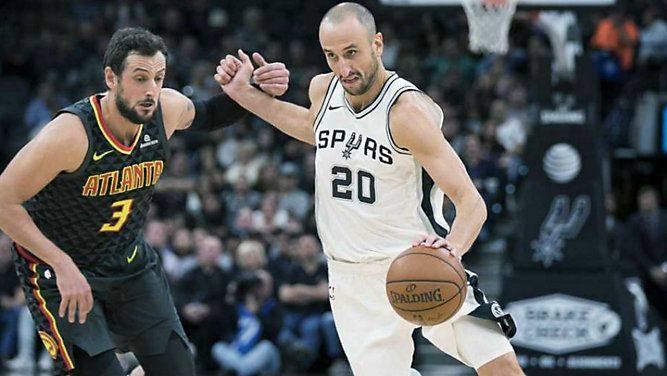 San Antonio Spurs guard Manu Ginobili (20), of Argentina, drives around Atlanta Hawks forward Marco Belinelli, of Italy, during the first half of an NBA basketball game, Monday, Nov. 20, 2017, in San Antonio. (AP Photo/Darren Abate)