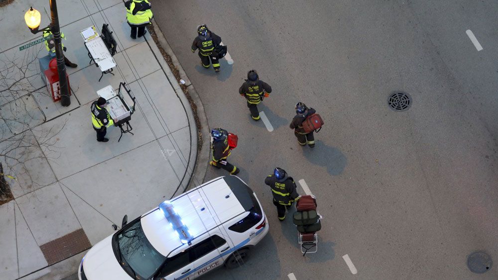 Chicago Fire crews help care for the wounded after a shooting at Mercy Hospital Monday. (Associated Press)