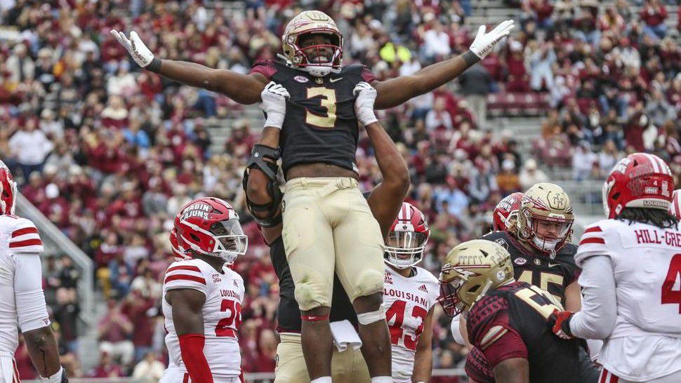 Florida State running back Trey Benson (3) is lifted, in celebration of his touchdown, by offensive lineman Jazston Turnetine during the third quarter of an NCAA college football game against Louisiana on Saturday, Nov. 19, 2022, in Tallahassee, Fla. (AP Photo/Gary McCullough)