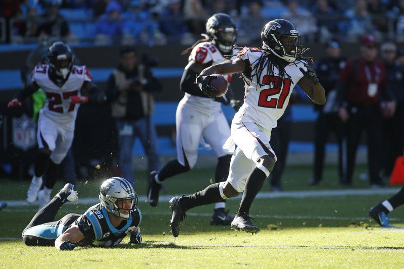 Atlanta Falcons cornerback Desmond Trufant (21) runs while Carolina Panthers running back Christian McCaffrey (22) misses the tackle during the first half of an NFL football game in Charlotte, N.C., Sunday, Nov. 17, 2019. (AP Photo/Brian Blanco)