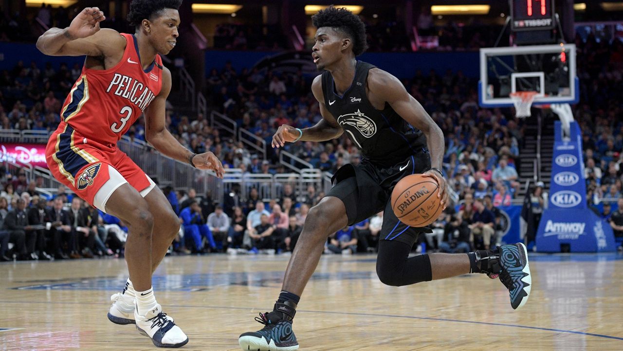 On March 20, 2019, before he tore his left knee ligament,  Magic forward Jonathan Isaac (1) sets up for a shot in front of then-New Orleans Pelicans forward Stanley Johnson (3). (AP Photo/Phelan M. Ebenhack)
