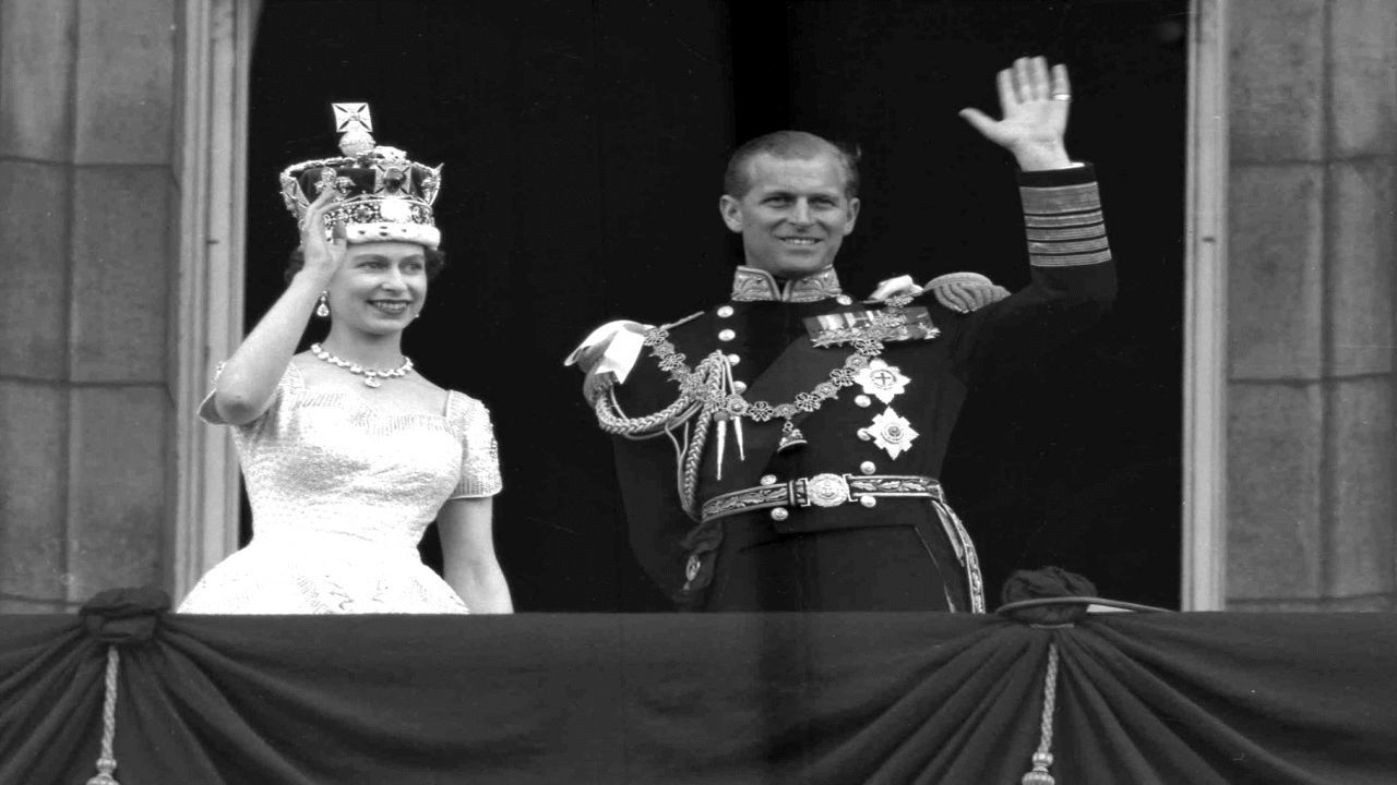 FILE - This is a June. 2, 1953 file photo of Britain's Queen Elizabeth II and Prince Philip, Duke of Edinburgh, as they wave to supporters from the balcony at Buckingham Palace, following her coronation at Westminster Abbey. London. (AP Photo/Leslie Priest, File)