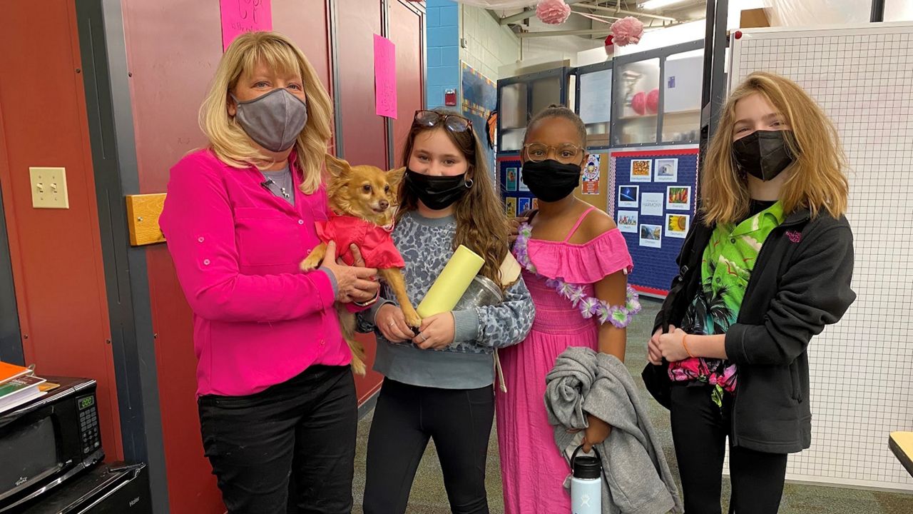 Pattie Koth with her students and her dog Tiny 