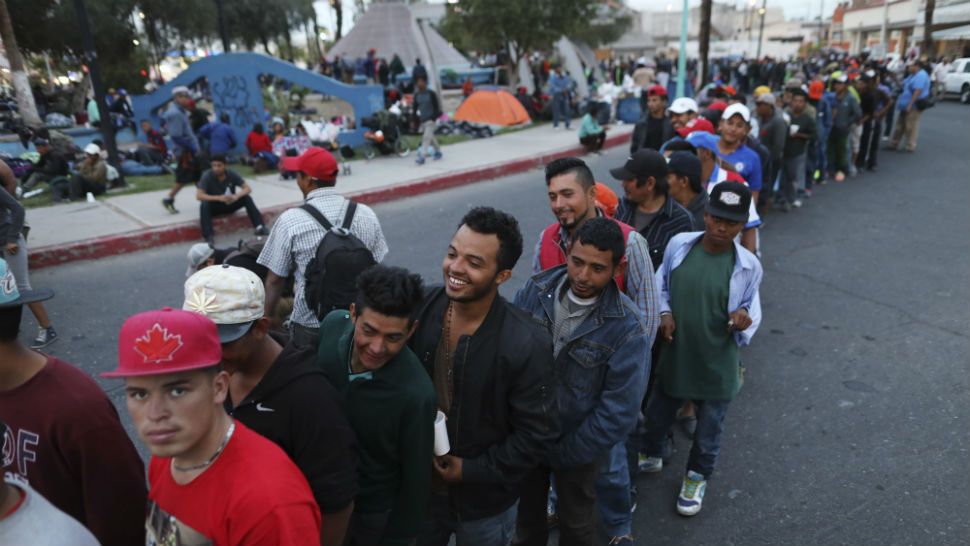 Central American migrants, as part of the Central American caravan trying to reach the United States, wait in a line to receive donated dinner downtown in Mexicali, Mexico, Monday, Nov. 19, 2018. The United States closed off northbound traffic for several hours at the busiest border crossing with Mexico to install new security barriers on Monday, a day after hundreds of Tijuana residents protested against the presence of thousands of Central American migrants. (AP Photo/Rodrigo Abd)