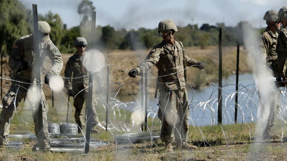 U.S. Troops laying wire at the border. (AP Photograph)