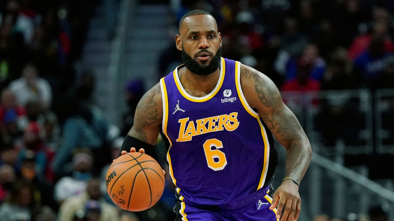 Los Angeles Lakers forward LeBron James brings the ball up court during the first half of an NBA basketball game against the Detroit Pistons, Sunday, Nov. 21, 2021, in Detroit. (AP Photo/Carlos Osorio)