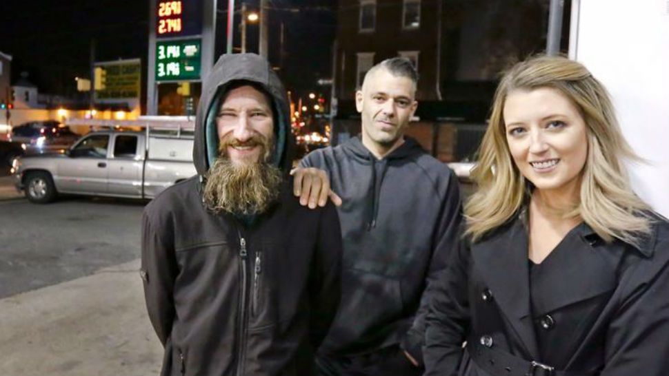 In this Nov. 17, 2017 photo, Johnny Bobbitt Jr., left, Kate McClure, right, and McClure's boyfriend Mark D'Amico pose at a CITGO station in Philadelphia. When McClure ran out of gas, Bobbitt, who is homeless, gave his last $20 to buy gas for her. (Elizabeth Robertson, AP)