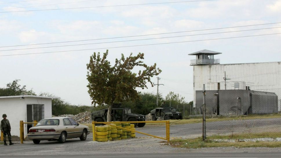 In this Sept. 18, 2012 file photo, Mexican army soldiers guard an entrance to the state prison in Piedras Negras, Mexico. Officially it was a prison, but inside it hid another reality: a center of operations where the Zetas cartel modified vehicles and manufactured uniforms, locked up kidnap victims and dissolved bodies in acid, according to a College of Mexico report released Tuesday, Nov. 21, 2017, based on witness statements, documents and public data. (Adriana Alvarado, File/Associated Press)