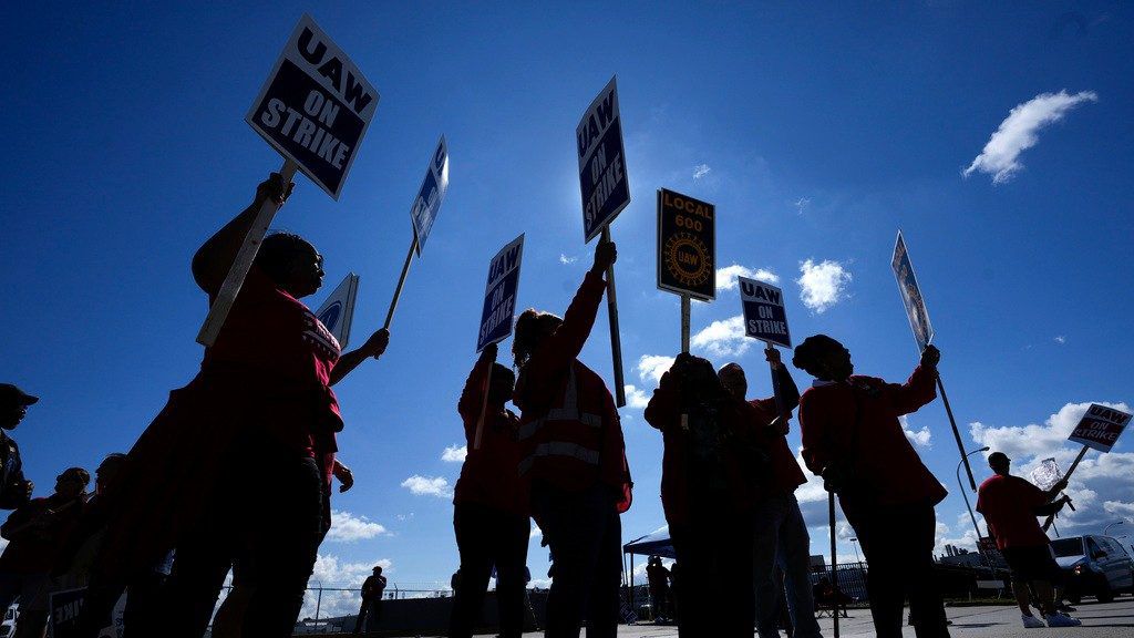 United Auto Workers members picket at the Ford Michigan Assembly Plant in Wayne, Mich., Monday, Sept. 18, 2023. New union agreements with Detroit automakers reached during the past week will cost Ford, Stellantis and General Motors over $1 billion per year by the time they take effect in four years. (AP Photo/Paul Sancya, File)
