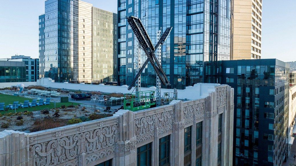 An "X" sign rests atop the company headquarters in downtown San Francisco, on July 28, 2023. (AP Photo/Noah Berger, File)