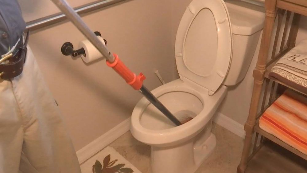 Unclogging a toilet the day after Thanksgiving. It's a particularly busy day for plumbers, they say. 