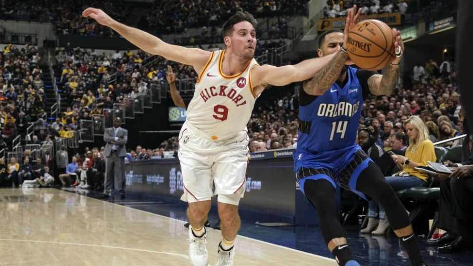 Indiana Pacers guard T.J. McConnell (9) goes after a loose ball against Orlando Magic guard D.J. Augustin (14) during the first half of an NBA basketball game in Indianapolis, Saturday, Nov. 23, 2019. (AP Photo/AJ Mast)