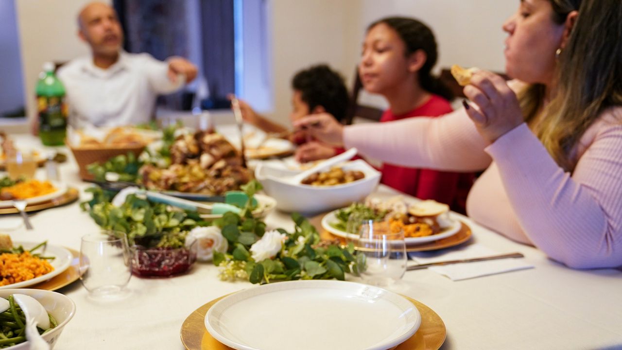 family around dining table for thanksgiving