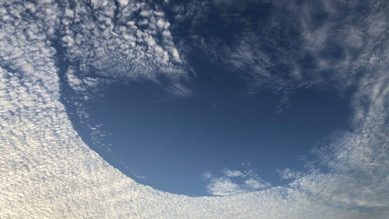 Sent to us with the Spectrum News 13 app: A large part appears to form a hole in the clouds over Kissimmee on Saturday afternoon. (Shawn Vanlester/viewer)