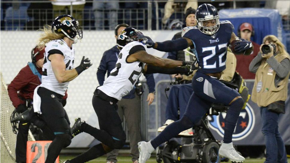 Tennessee Titans running back Derrick Henry (22) runs past Jacksonville Jaguars safety Jarrod Wilson (26) as Henry scores a touchdown on a 74-yard run in the second half of an NFL football game Sunday, Nov. 24, 2019, in Nashville, Tenn. (AP Photo/Mark Zaleski)