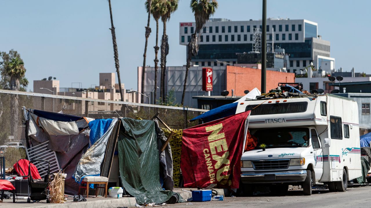 Homeless encampments block the street on an overpass of the Hollywood freeway in Los Angeles, in July 7, 2021. (AP Photo/Damian Dovarganes, File)