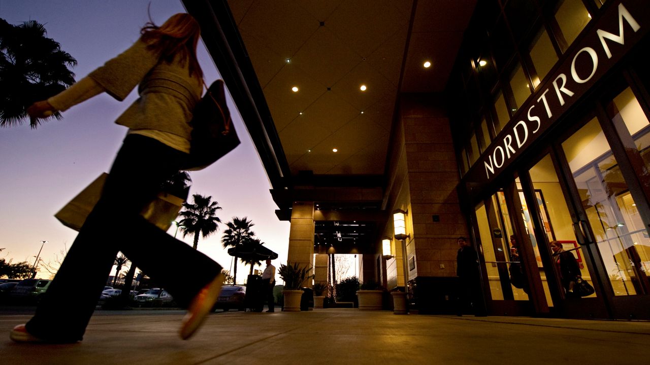 In this Feb. 11, 2011 file photo, a customer walks out of Nordstrom in the Canoga Park section of Los Angeles. (AP Photo/Mark Terrill, File)