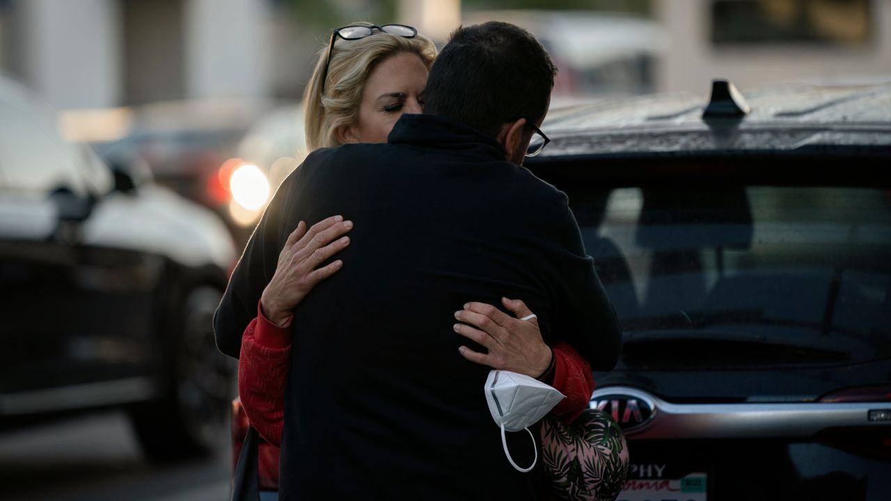 Traveling to Kansas City, Mo., Kate Krystowiak hugs her boyfriend, Jimmy Bradley, after she was dropped off at the Los Angeles International Airport in Los Angeles, Wednesday, Nov. 24, 2021. (AP Photo/Jae C. Hong)