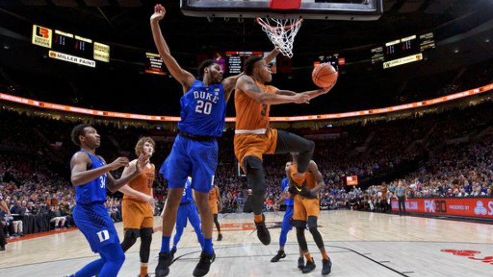 Texas guard Jacob Young shoots next to Duke center Marques Bolden during the first half of an NCAA college basketball game in the Phil Knight Invitational tournament in Portland, Ore., Friday, Nov. 24, 2017. (AP Photo/Craig Mitchelldyer)