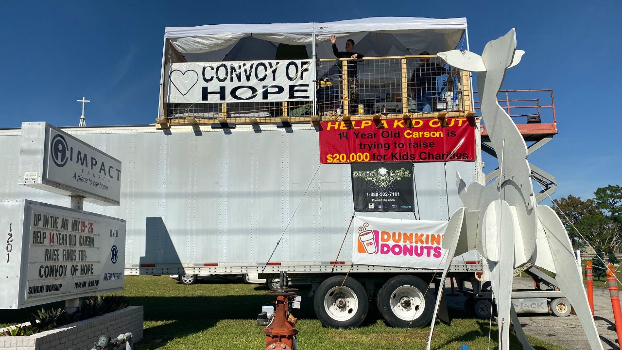 Carson Rudy and his father, Shawn, plan to spend the Thanksgiving holiday on top of a semi parked in front of their Lake Wales church to raise money for a humanitarian group. (Stephanie Claytor/Spectrum News)
