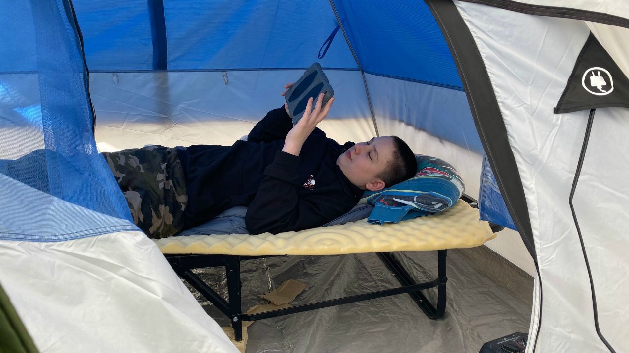 Carson Rudy and his father, Shawn, plan to spend the Thanksgiving holiday on top of a semi parked in front of their Lake Wales church to raise money for a humanitarian group. (Stephanie Claytor/Spectrum News)