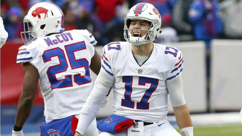 Photo: Buffalo Bills Josh Allen hands the ball off to Frank Gore