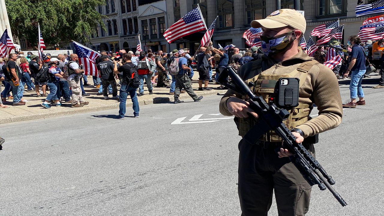 A member of the Oath Keepers armed militia group observes protests in Louisville.