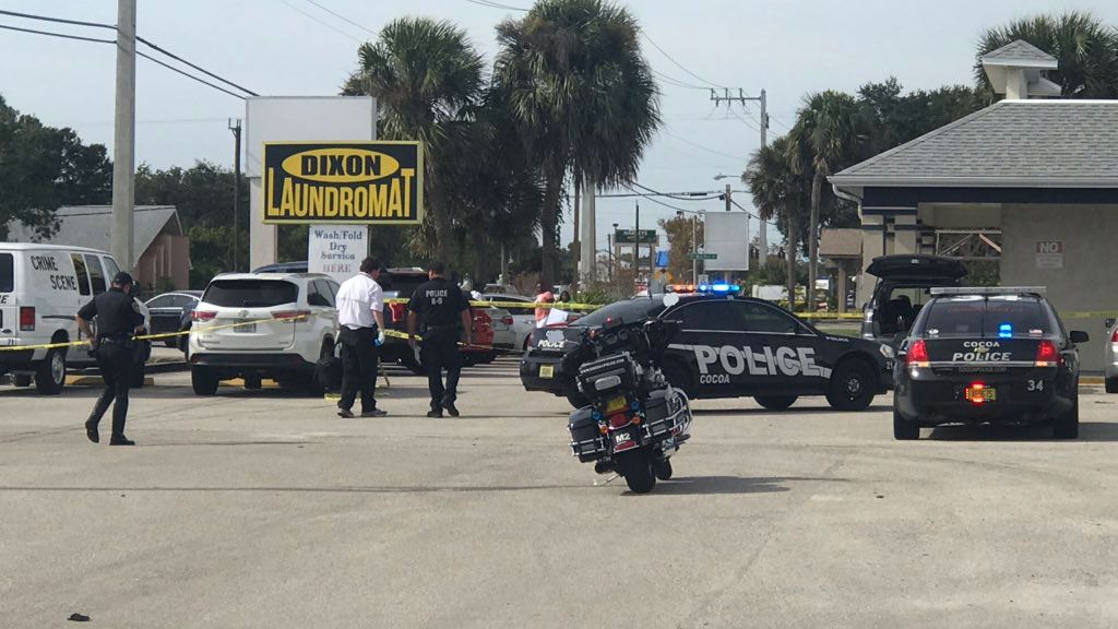 Police put up crime scene tape at the Dixon Laundromat in Cocoa after a shooting there. (Greg Pallone, Spectrum News)