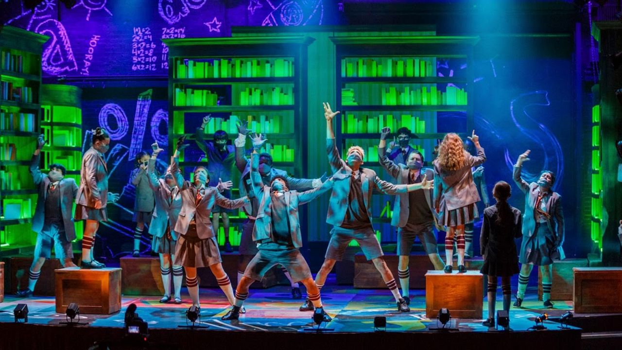 The cast of "Matilda" at the Garden Theatre in Winter Garden sing and dance in masks. (Garden Theatre)