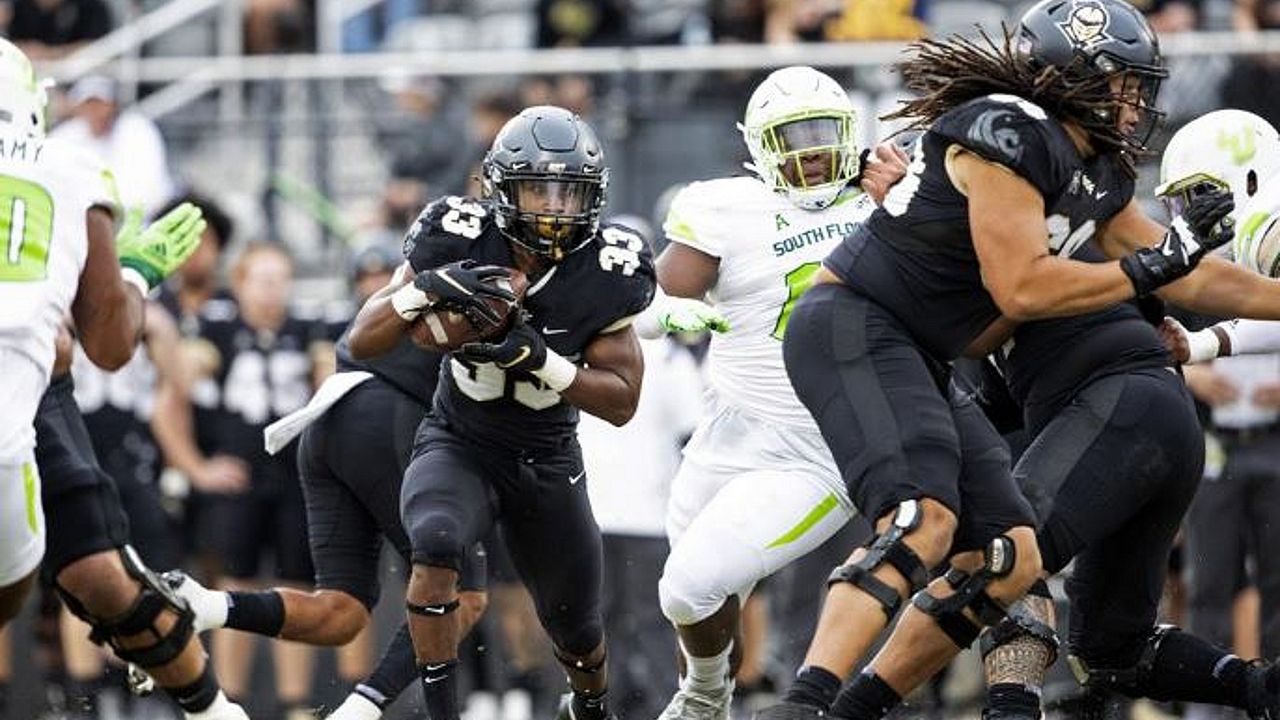 UCF running back Trillion Coles runs the ball against USF in the team's annual War on I-4 rivalry matchup. (Willie J. Allen Jr./Orlando Sentinel via AP)