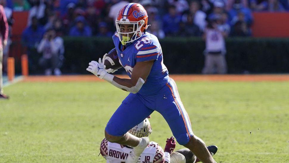 Florida running back Malik Davis (20) runs past Florida State defensive back Jarvis Brownlee Jr. during the second half of an NCAA college football game, Saturday, Nov. 27, 2021, in Gainesville, Fla. (AP Photo/John Raoux)