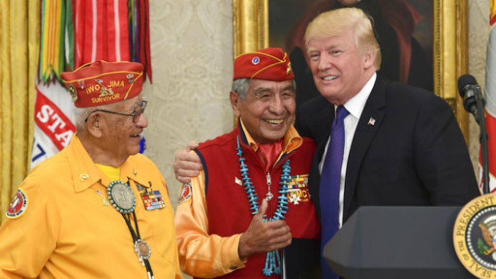 President Donald Trump, right, meets with Navajo Code Talkers Peter MacDonald, center, and Thomas Begay, left, in the Oval Office of the White House in Washington, Monday, Nov. 27, 2017. (AP Photo/Susan Walsh)