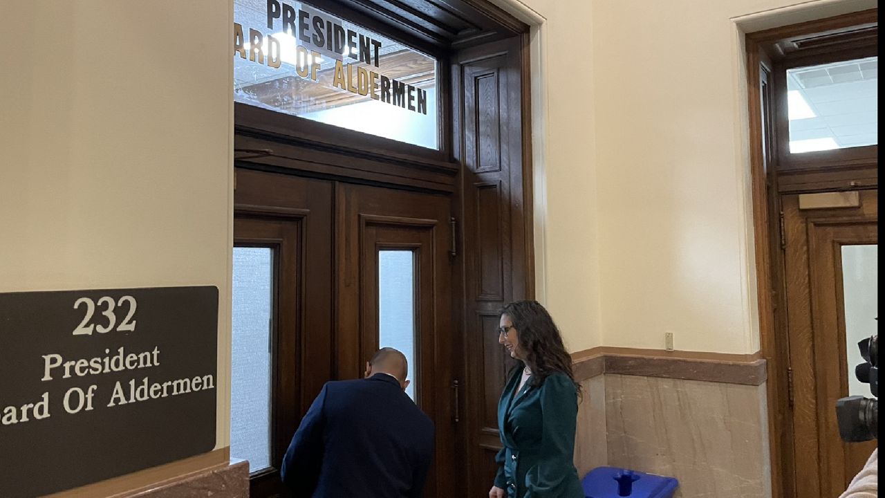 Jay Nelson, Chief of Staff to Megan Green, the new President of the St. Louis Board of Aldermen, lets Green into her new office following Monday's City Hall inauguration. (Spectrum News/Gregg Palermo)