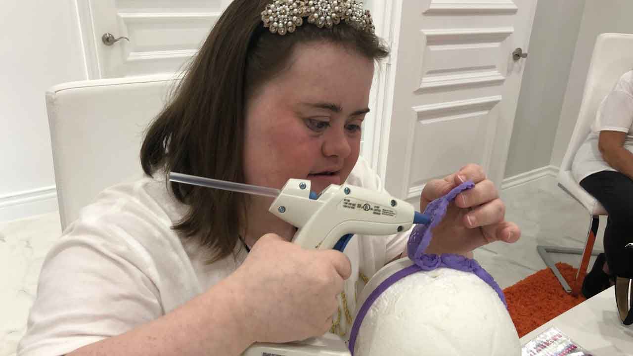 Maxine Simeone, 23, works on crafting one of her signature headbands. Maxine has Down syndrome, but it hasn't stopped her from expressing her creativity and starting a business called "Sparkles by Maxine." (Ashley Paul/Spectrum Bay News 9)