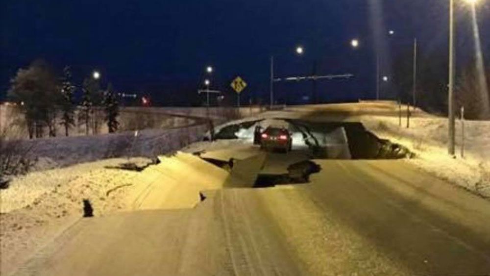 A vehicle is stuck after an earthquake buckles a highway in Anchorage, Alaska Friday. Photos provided by a Spectrum News viewer.