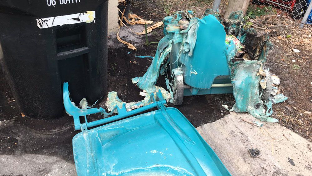 A trash can melted by fire in the Lake Eola Heights area of Orlando. There were five such fires overnight, officials said. (Erin Murray, Spectrum News)
