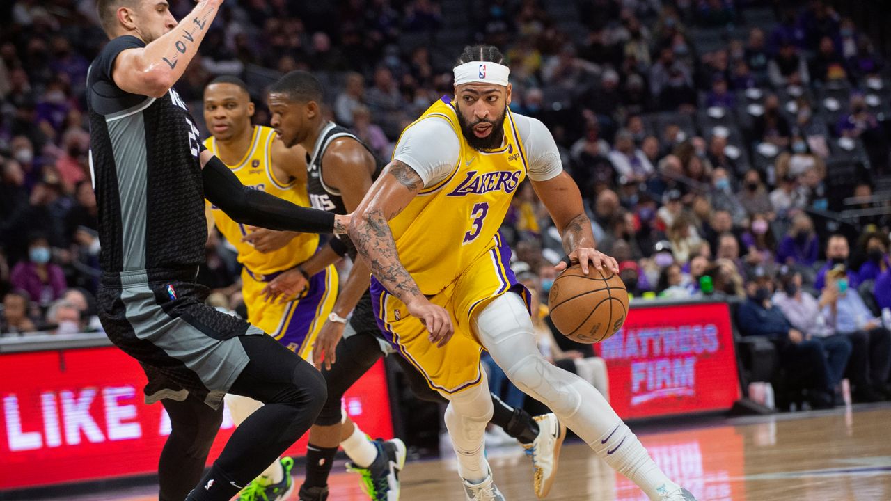 Sacramento Kings center Alex Len guards Los Angeles Lakers forward Anthony Davis (3) during the first quarter of an NBA basketball game in Sacramento, Calif., Tuesday, Nov. 30, 2021. (AP Photo/Randall Benton)