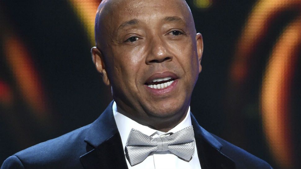 In this Feb. 6, 2015, file photo, hip-hop mogul Russell Simmons presents the Vanguard Award on stage at the 46th NAACP Image Awards in Pasadena, Calif. Simmons announced on Nov. 30, 2017, he would be stepping down... (Photo by Chris Pizzello/Invision/AP, File